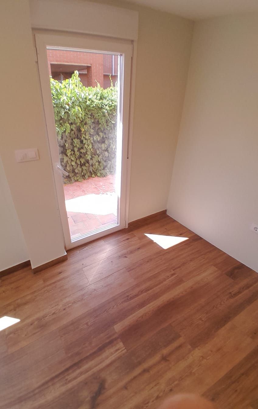 Estancia de chalet con suelo de madera y salida al jardín